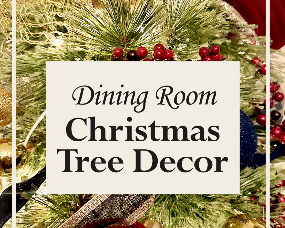 Red velvet Christmas ornaments hanging on tree branches with warm fairy lights